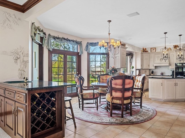 dining space featuring a notable chandelier and light tile patterned floors