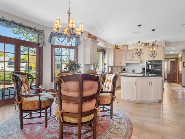 dining space featuring recessed lighting, light tile patterned flooring, and an inviting chandelier