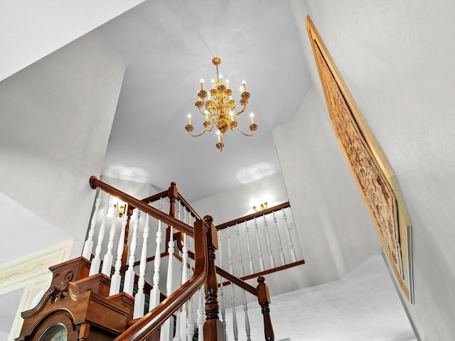 stairs featuring a chandelier