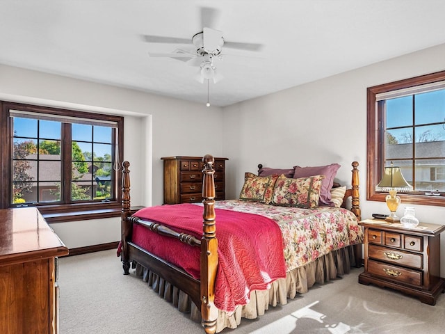 carpeted bedroom featuring ceiling fan and baseboards