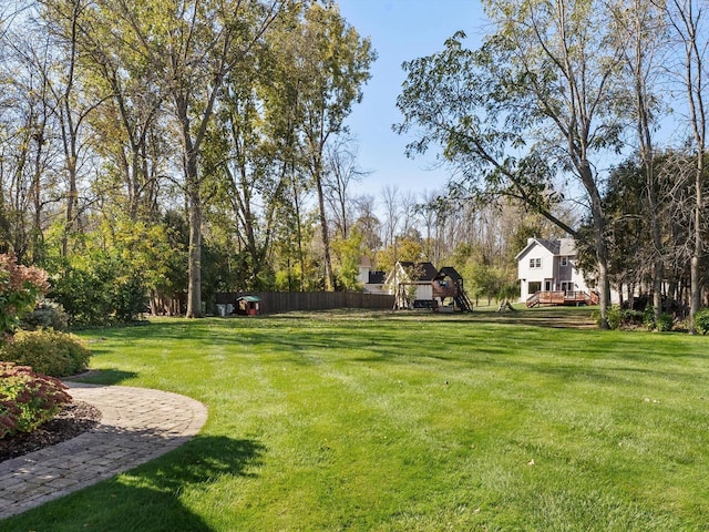 view of yard with fence and a playground