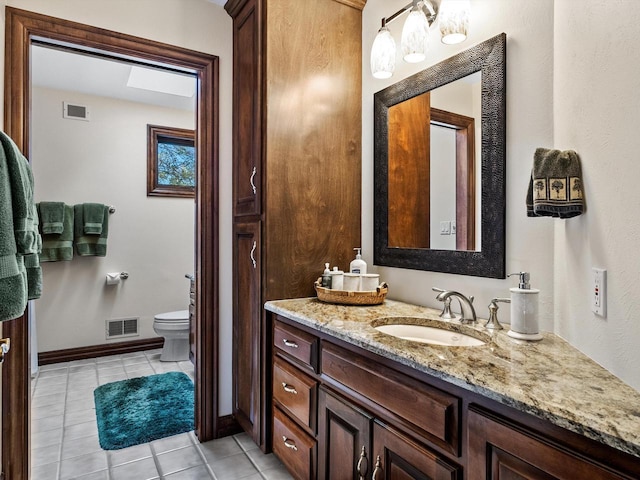 bathroom featuring tile patterned flooring, visible vents, vanity, and toilet