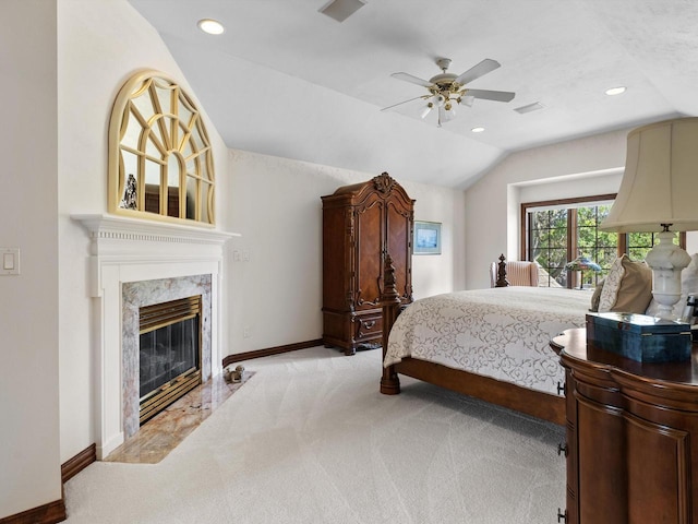 bedroom with recessed lighting, light colored carpet, a fireplace, baseboards, and vaulted ceiling