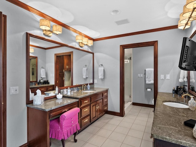 bathroom featuring tile patterned flooring, vanity, baseboards, ornamental molding, and a stall shower