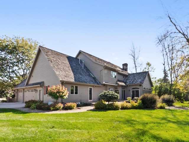 view of property exterior featuring a garage, a chimney, and a yard