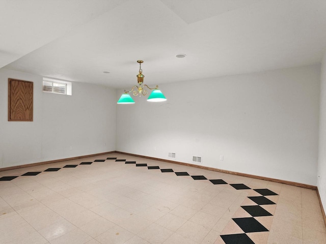 empty room featuring visible vents, baseboards, and tile patterned floors