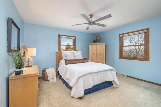 bedroom with ceiling fan, carpet flooring, visible vents, and baseboards