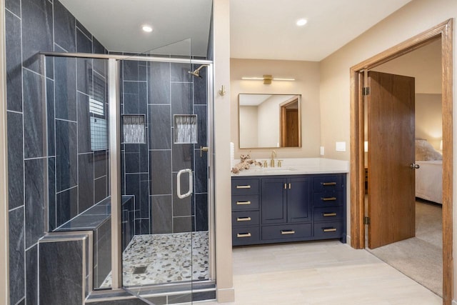 bathroom featuring a stall shower, recessed lighting, and vanity