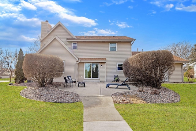 back of property with a patio area, a chimney, a fire pit, and a lawn