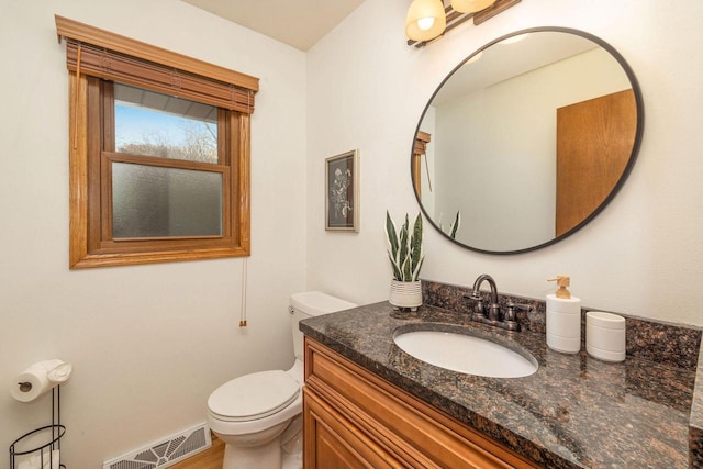 bathroom featuring visible vents, vanity, and toilet