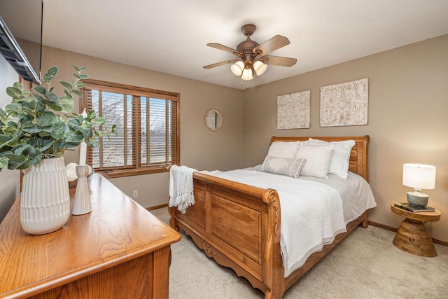 bedroom with baseboards, a ceiling fan, and light colored carpet