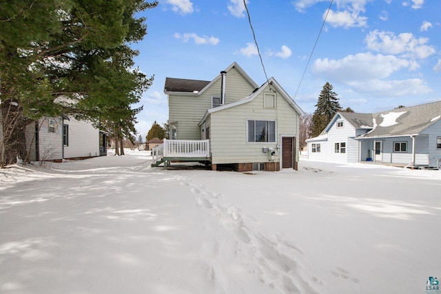 snow covered property featuring a wooden deck