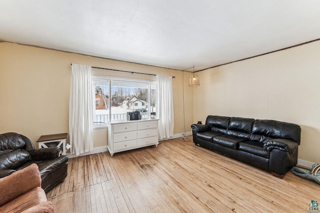 living area with light wood finished floors and baseboards