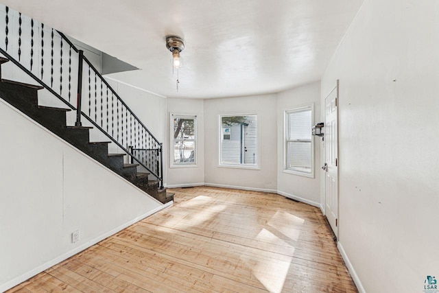 foyer with stairs, baseboards, and hardwood / wood-style floors