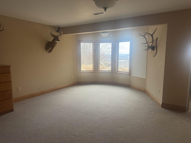 interior space featuring light carpet, visible vents, and baseboards