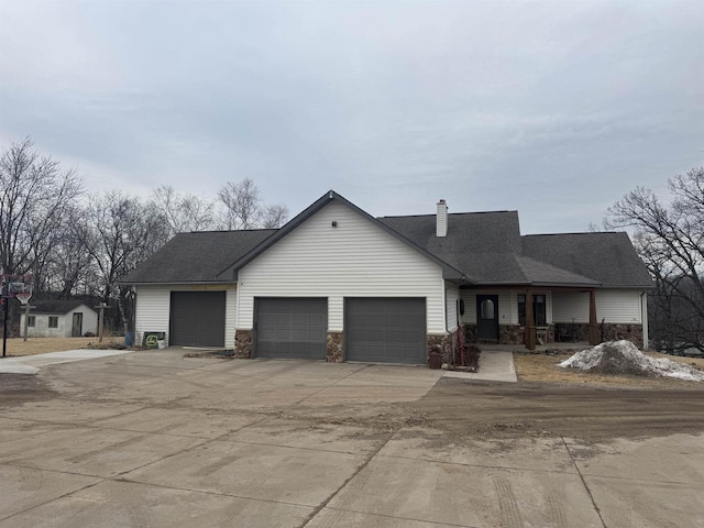 ranch-style house with a garage, driveway, a chimney, and roof with shingles