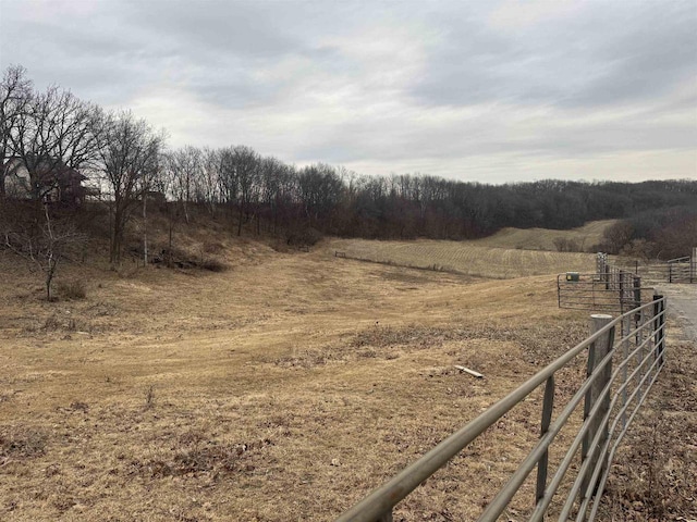 exterior space featuring fence and a rural view