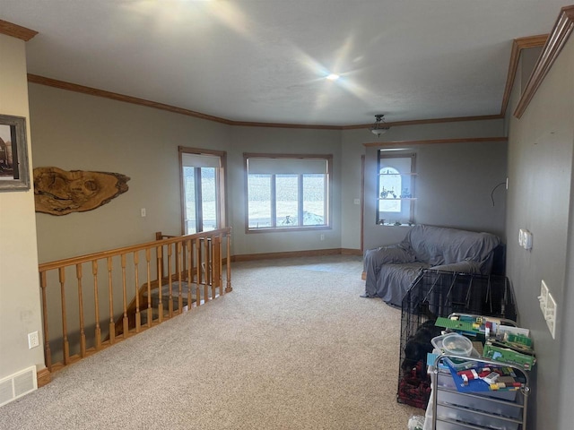 carpeted bedroom featuring ornamental molding, visible vents, ceiling fan, and baseboards