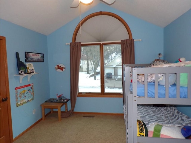 bedroom with visible vents, carpet, and vaulted ceiling