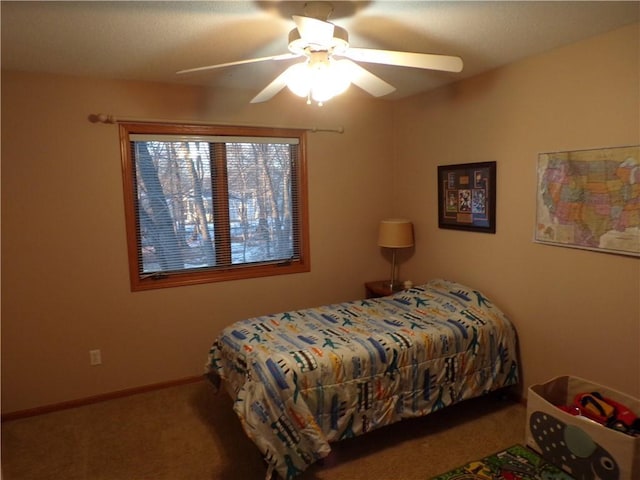 carpeted bedroom featuring baseboards and ceiling fan