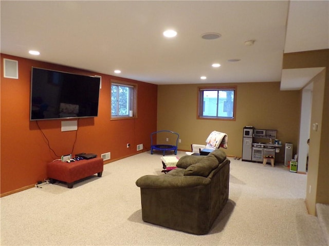 carpeted living room featuring recessed lighting, visible vents, and baseboards