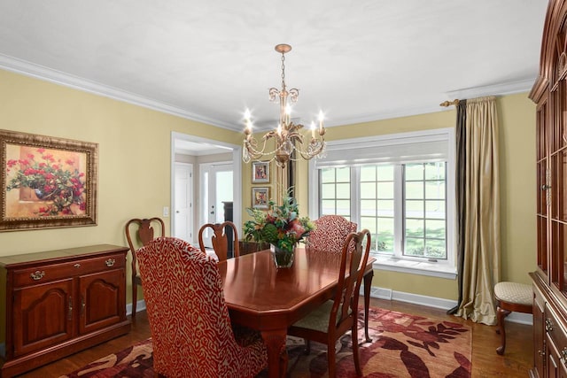 dining area with dark wood finished floors, crown molding, baseboards, and a chandelier