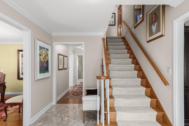 staircase with crown molding and baseboards