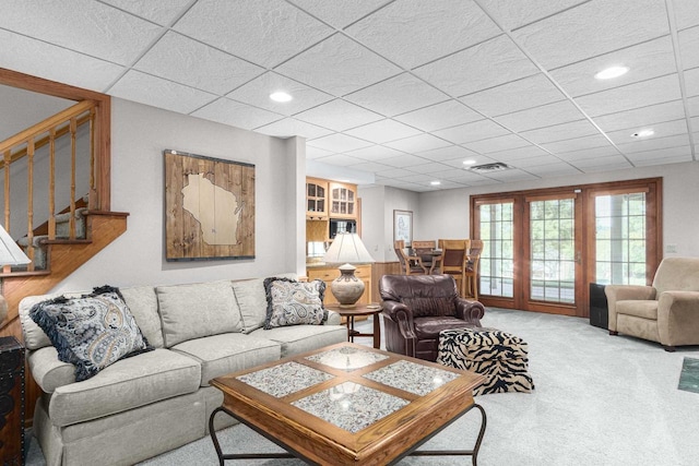 carpeted living room with stairway, recessed lighting, visible vents, and a paneled ceiling