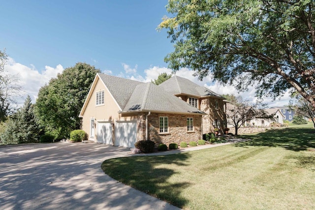 view of front facade with a front lawn, concrete driveway, roof with shingles, a garage, and stone siding