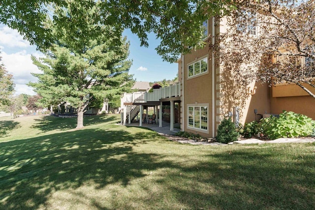 view of yard featuring a deck and stairs