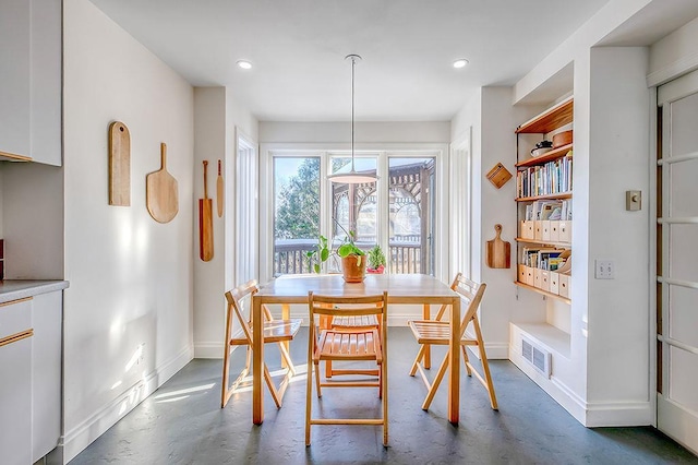 dining room with visible vents, recessed lighting, baseboards, and concrete flooring