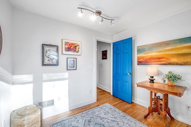 interior space featuring visible vents, baseboards, and wood finished floors