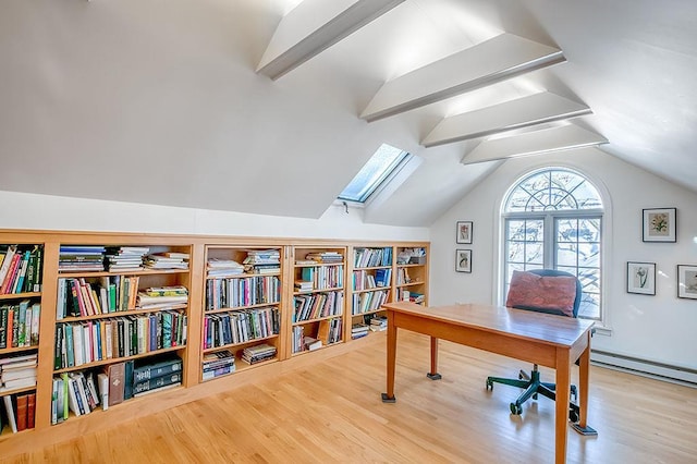 office space featuring lofted ceiling with skylight, wood finished floors, and a baseboard radiator