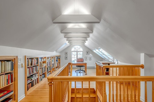 bonus room with lofted ceiling and light wood-style floors