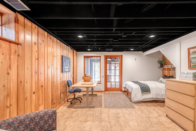 bedroom featuring visible vents and wood walls