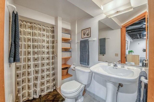 bathroom featuring a baseboard heating unit, baseboards, toilet, and tile patterned flooring