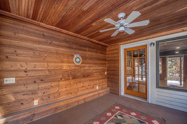 view of exterior entry with a ceiling fan