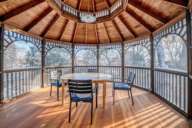 wooden deck with a gazebo and outdoor dining space