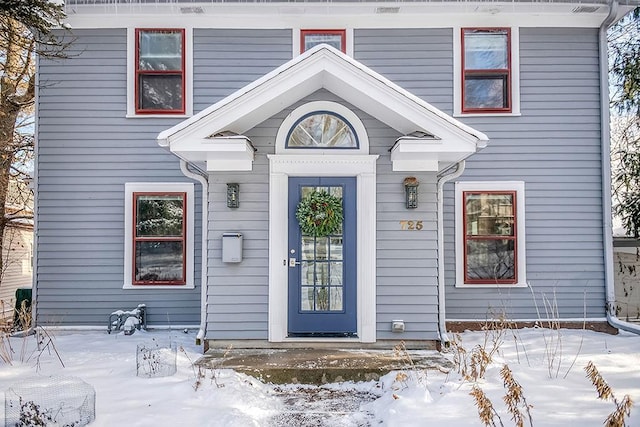 view of snow covered property entrance