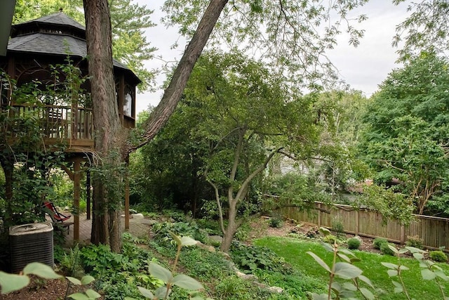 view of yard featuring a gazebo, central AC, and fence