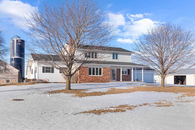 traditional-style home with brick siding and a garage