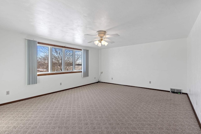 empty room with visible vents, ceiling fan, baseboards, and carpet