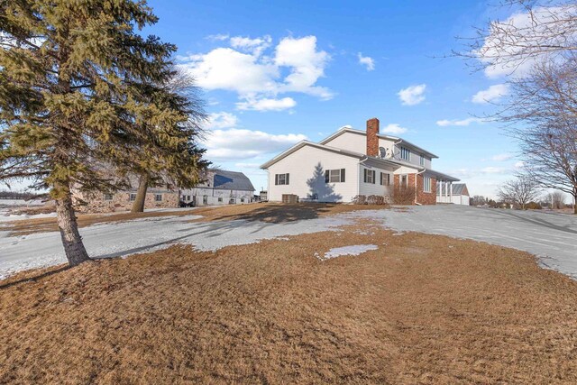 view of front of property with aphalt driveway and a chimney