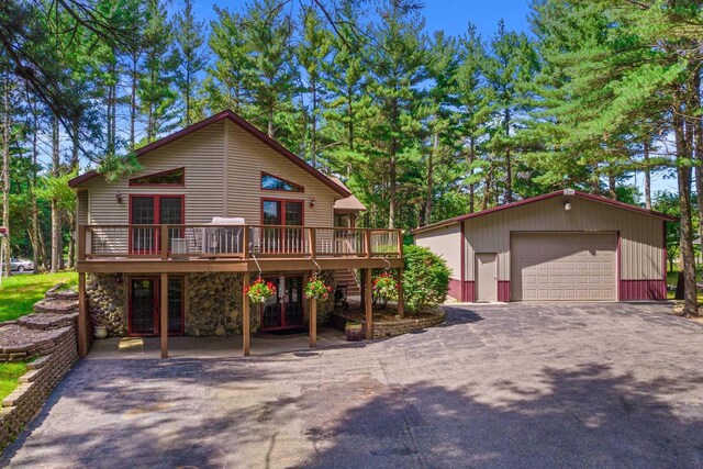 1680 N Aurora Ln, Nekoosa, WI 54457 - chalet / cabin with a garage, a wooden deck, and an outdoor structure