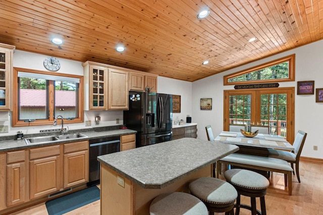 1680 N Aurora Ln, Nekoosa, WI 54457 - kitchen with a kitchen bar, a sink, black fridge with ice dispenser, dishwasher, and vaulted ceiling