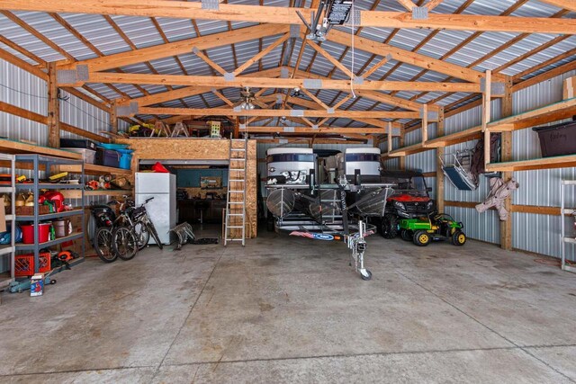 1680 N Aurora Ln, Nekoosa, WI 54457 - garage with metal wall and freestanding refrigerator