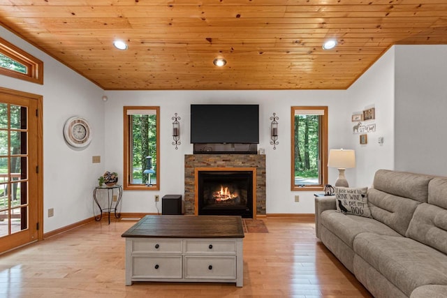 1680 N Aurora Ln, Nekoosa, WI 54457 - living area featuring lofted ceiling, wood ceiling, a warm lit fireplace, and light wood finished floors