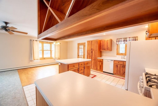 kitchen with a kitchen island, dishwasher, light countertops, gas range oven, and beam ceiling