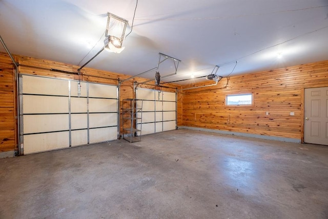 garage with wooden walls and a garage door opener