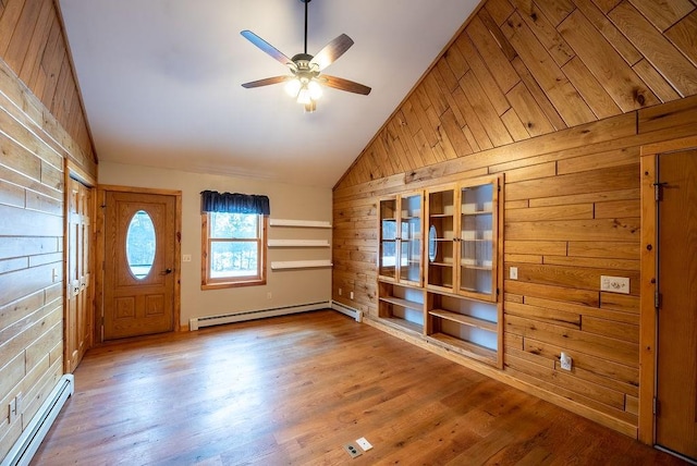 entryway with a baseboard radiator, wood finished floors, and wood walls